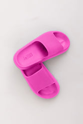 Pink slide sandals on a light gray background