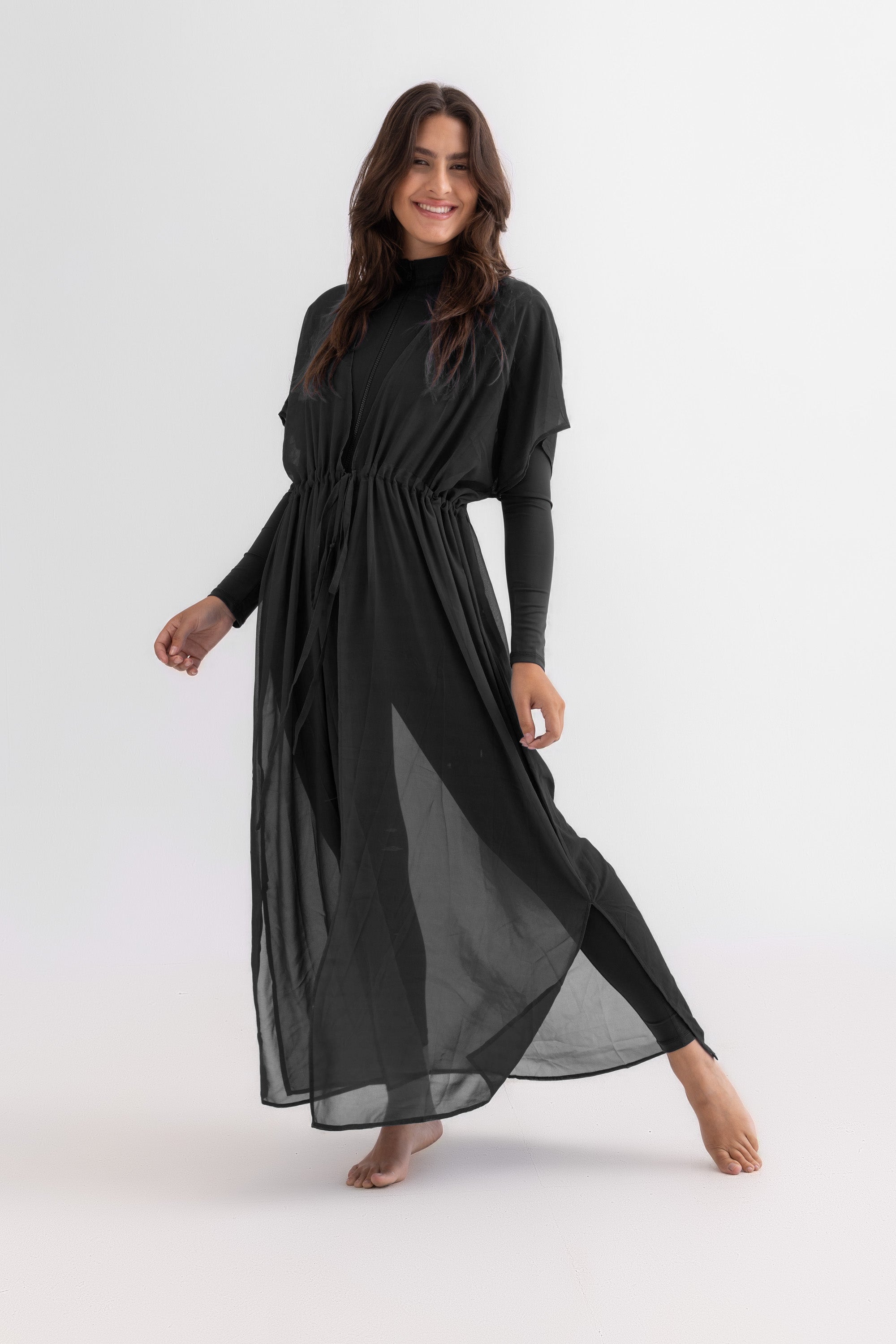 Woman wearing a black dress on a white background