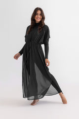Woman wearing a black dress on a white background