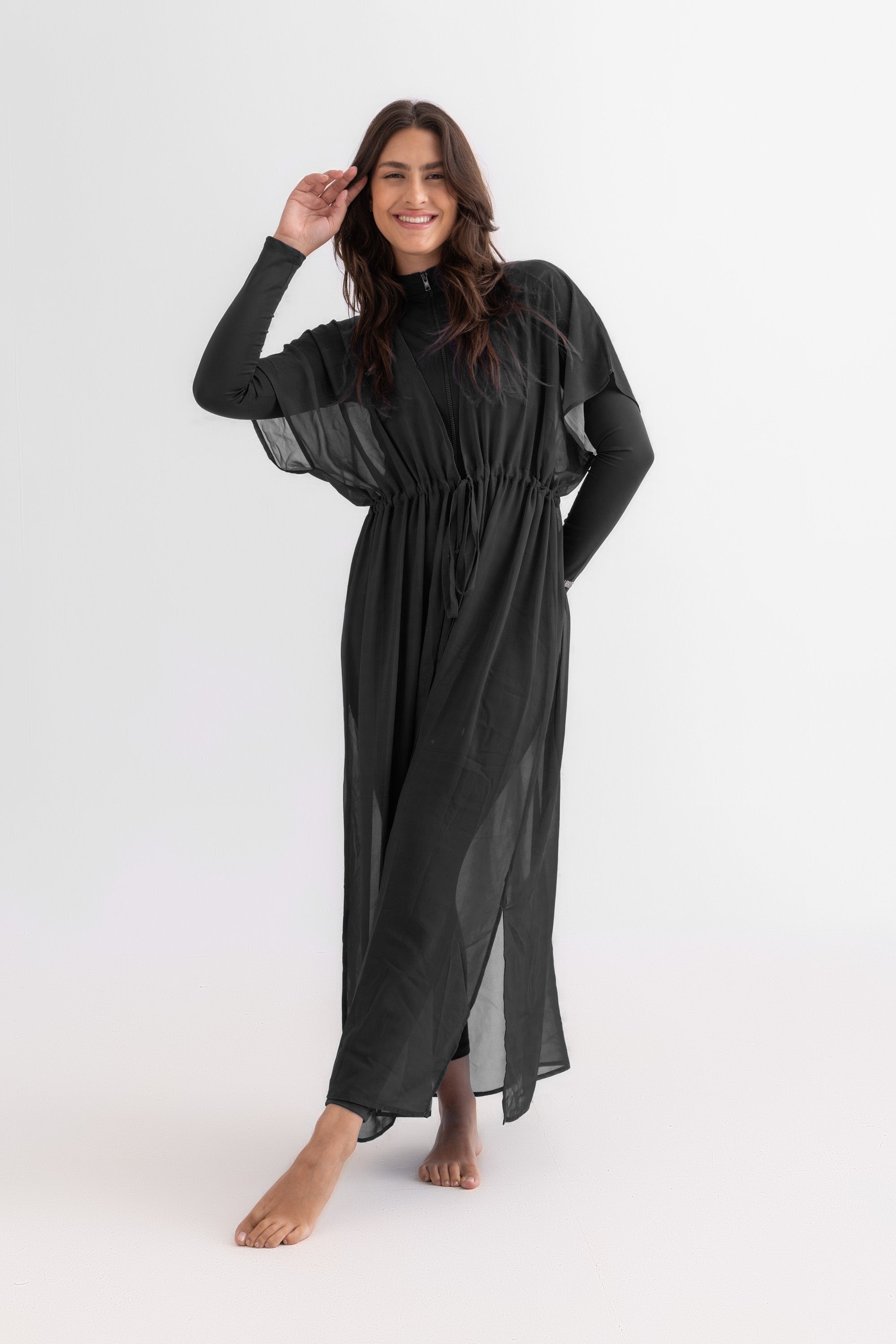 Woman wearing a black dress against a white background