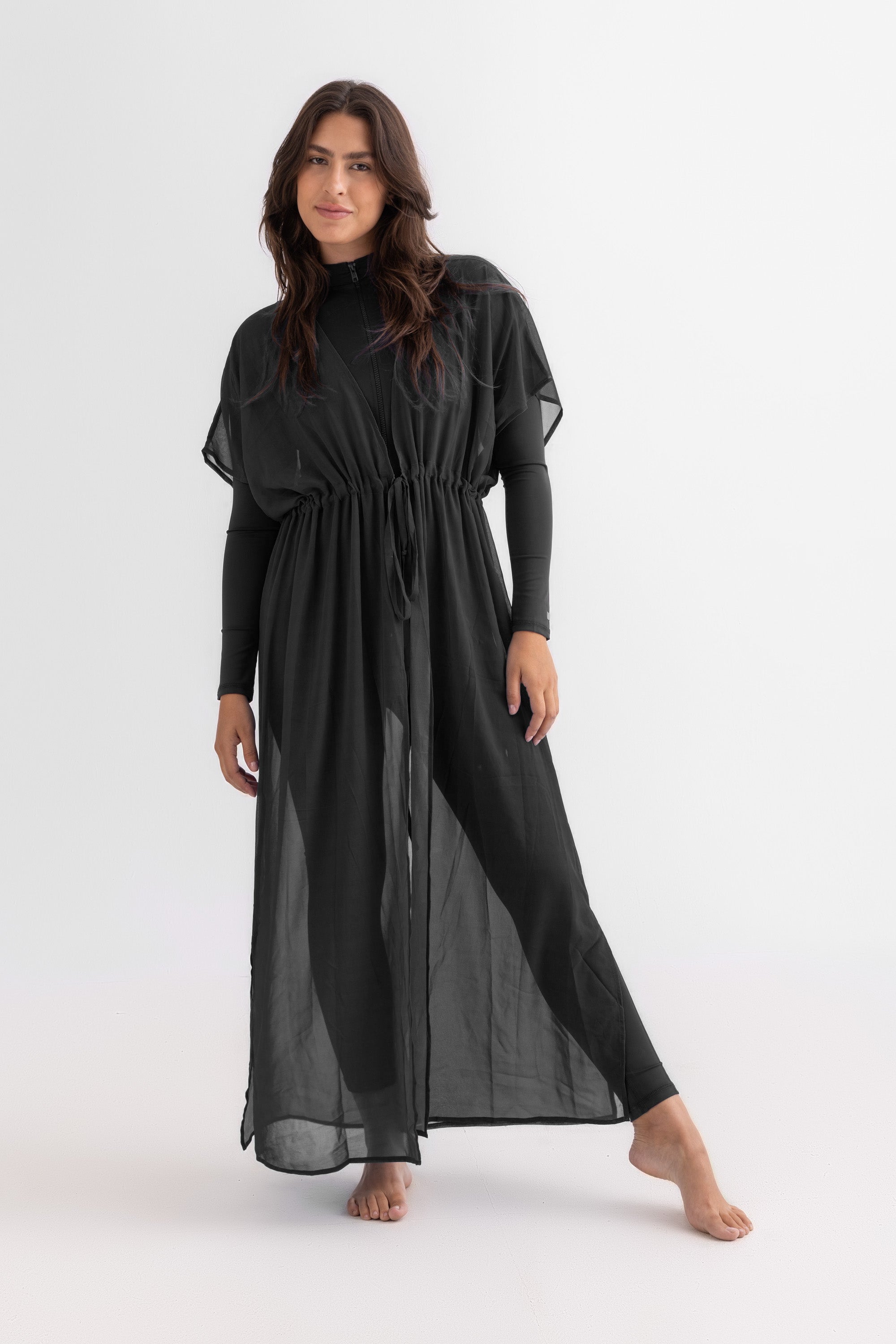 Woman wearing a black dress on a white background
